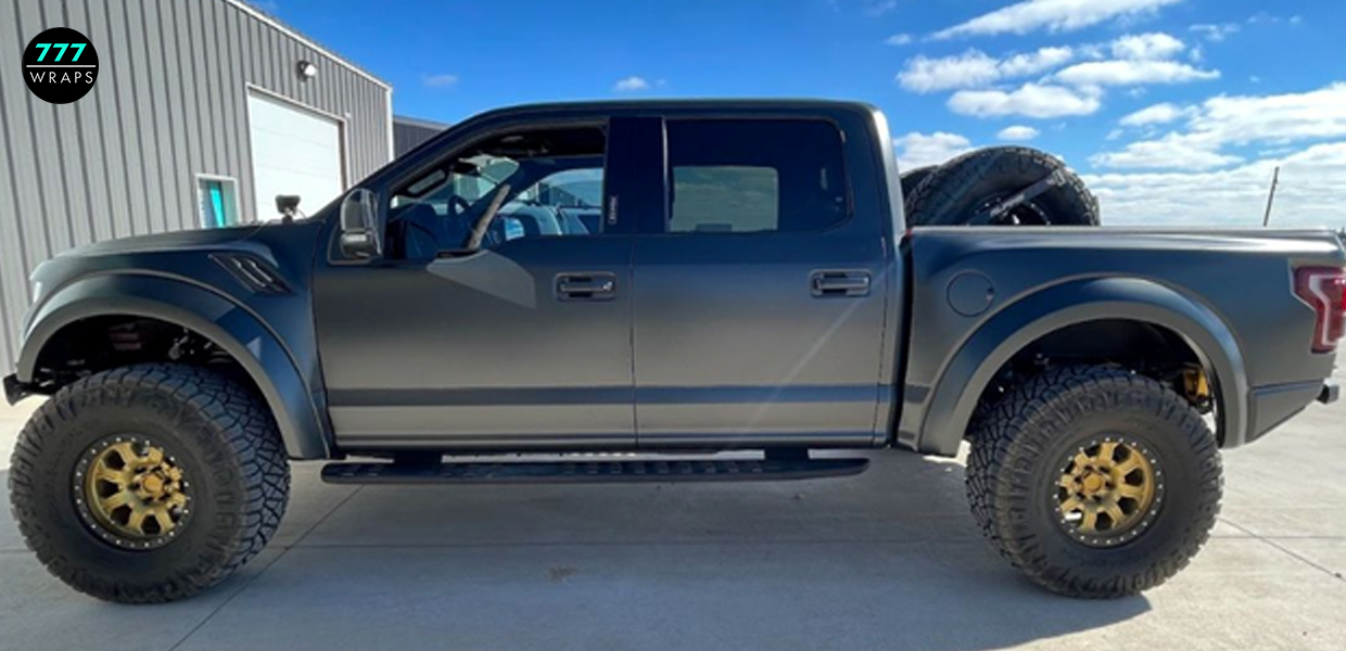 Wrapped pickup truck parked outside a vehicle wrap shop